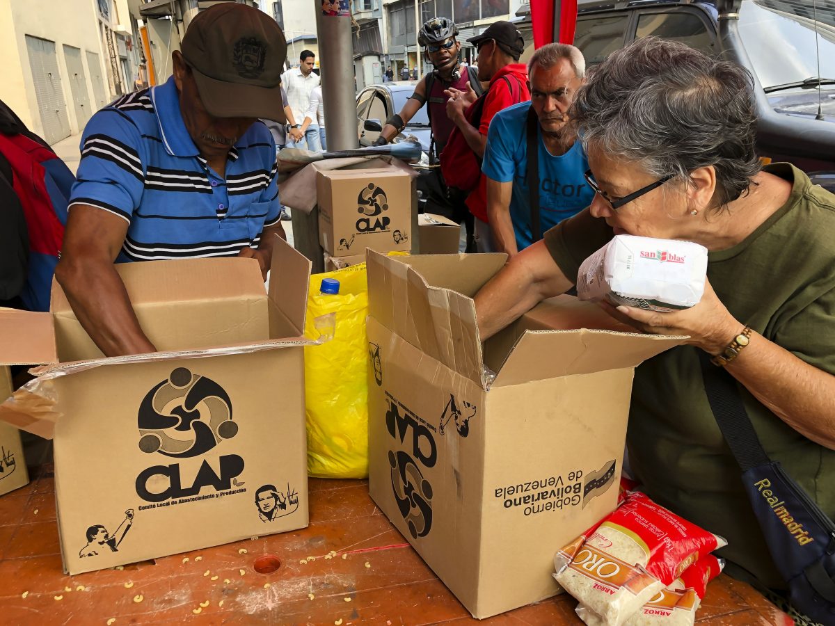 Neighbors of barrio Union of Petare open boxes of food program CLAP in Caracas, Venezuela