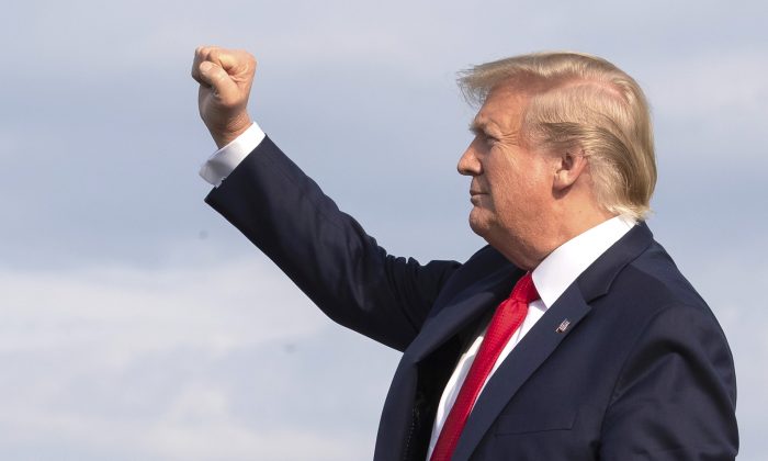 President Donald Trump gestures as he disembarks Air Force One upon arrival at Wheeling, W.Va., on July 24, 2019. (AP Photo/Manuel Balce Ceneta)