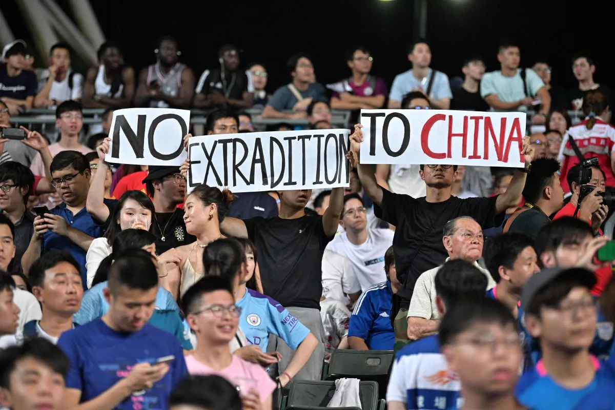 Protesters hold up signs related to the recent political events in the territory, during a football match between English Premier League club Manchester City and Hong Kong side Kitchee at Hong Kong Stadium on July 24, 2019. (Anthony Wallace/AFP/Getty Images)