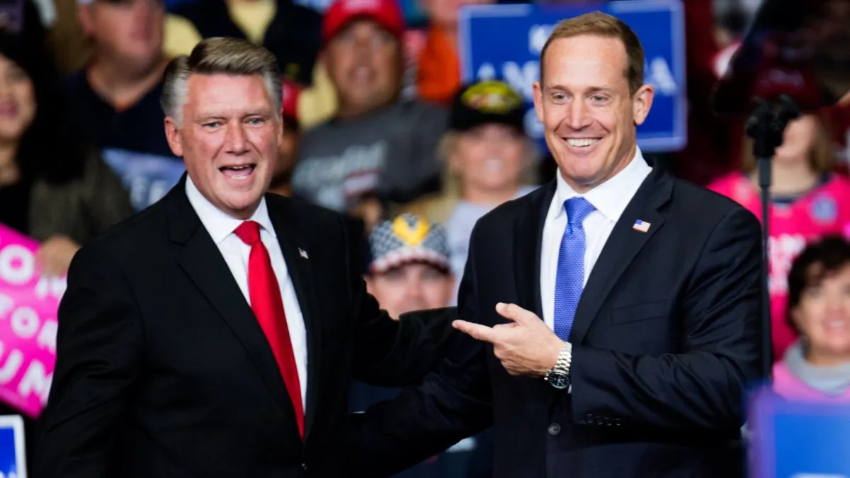 Republican Congressional candidate for North Carolina's 13th district Ted Budd (R), and 9th district Mark Harris (L) are introduced by President Donald Trump during a campaign rally at the Bojangles Coliseum in Charlotte, N.C., on Oct. 26, 2018. (Sean Rayford/Getty Images)