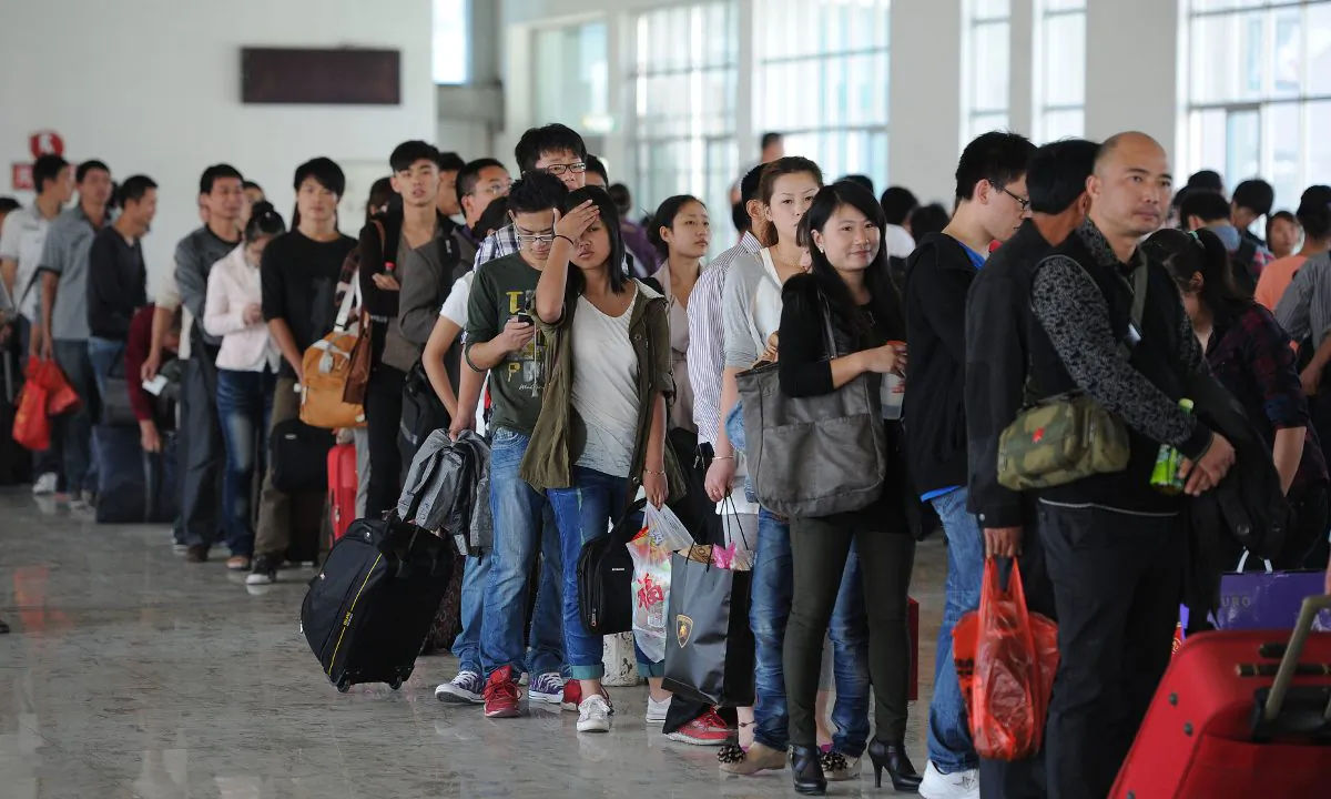 Passengers line up at a train station in China. (AFP/AFP/GettyImages)