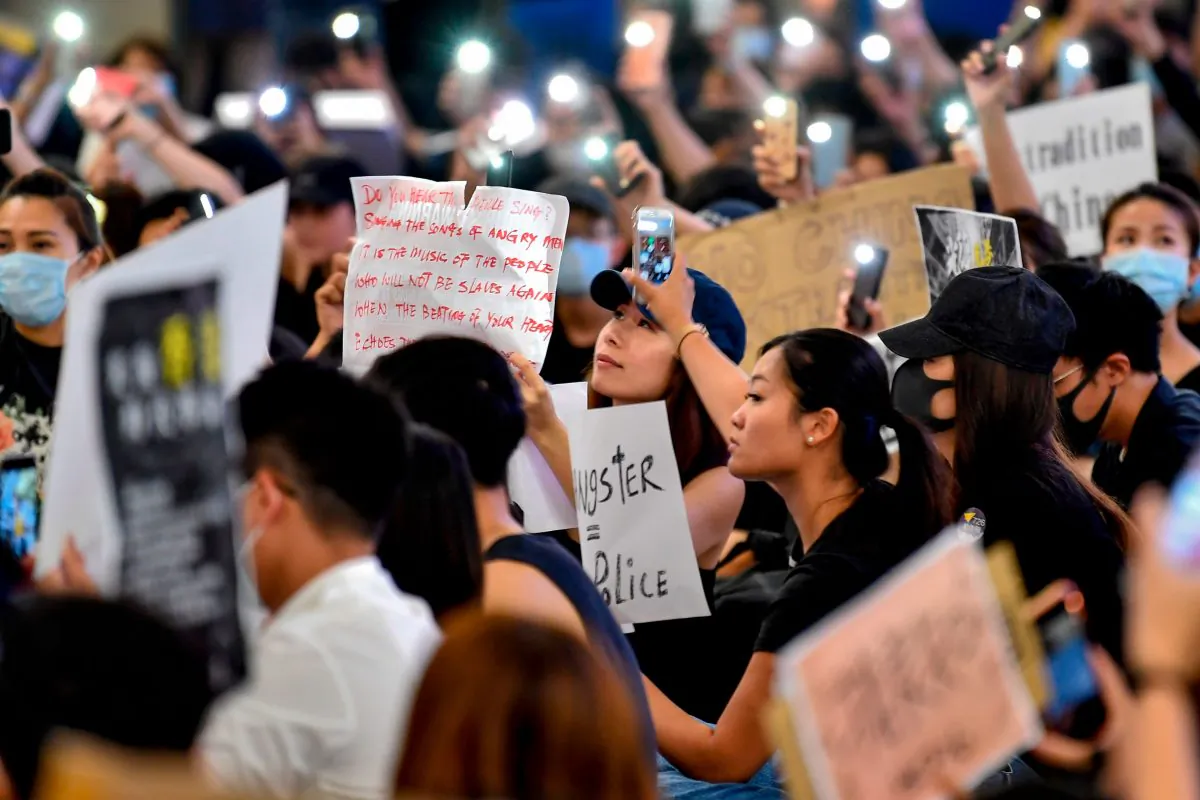 Protesters hold up their mobile phone torches as they rally against a controversial extradition bill at the arrivals hall of the international airport in Hong Kong on July 26, 2019. (Anthony Wallace/AFP/Getty Images)