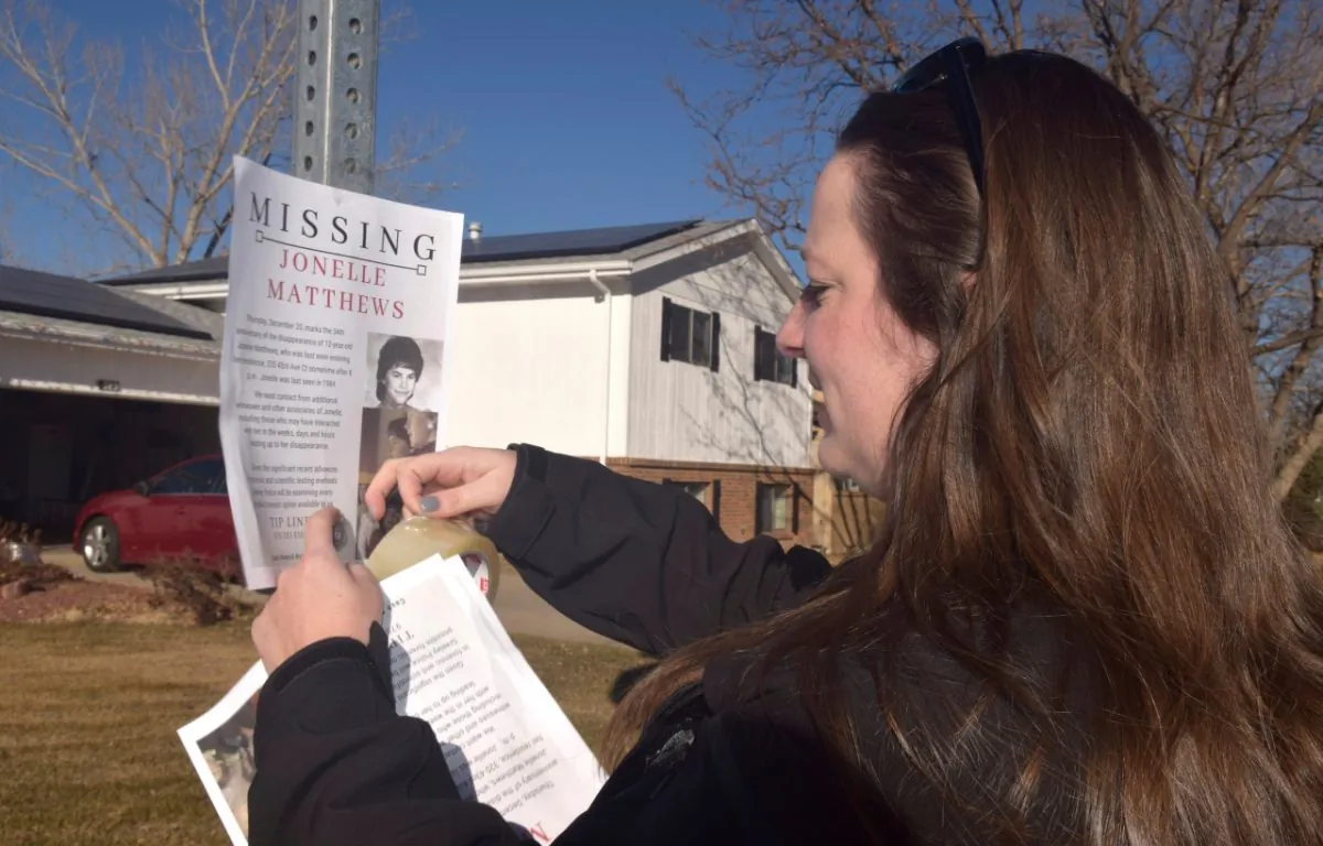 A victims advocate posts a flyer of a missing persons poster for Jonelle Matthews in Greeley, Colo., in December 2018. (Joe Moylan/The Greeley Tribune via AP)