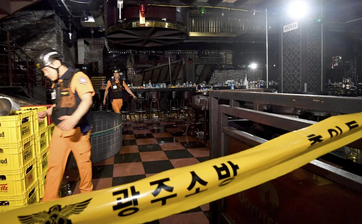 Rescue workers walk to inspect a collapsed internal balcony at a nightclub in Gwangju, South Korea, on July 27, 2019. (Shin Dae-hee/Newsis via AP)