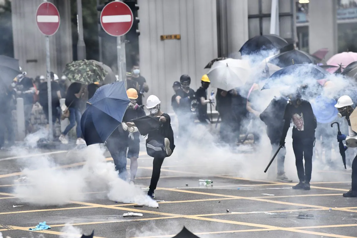 Anti-riot police fire tear gas at protesters during a demonstration in the district of Yuen Long in Hong Kong on July 27, 2019. The protesters were marching through a Hong Kong town near the Chinese border to rally against suspected triad gangs who beat up pro-democracy demonstrators there the previous weekend. (Anthony WallaceE/AFP/Getty Images)