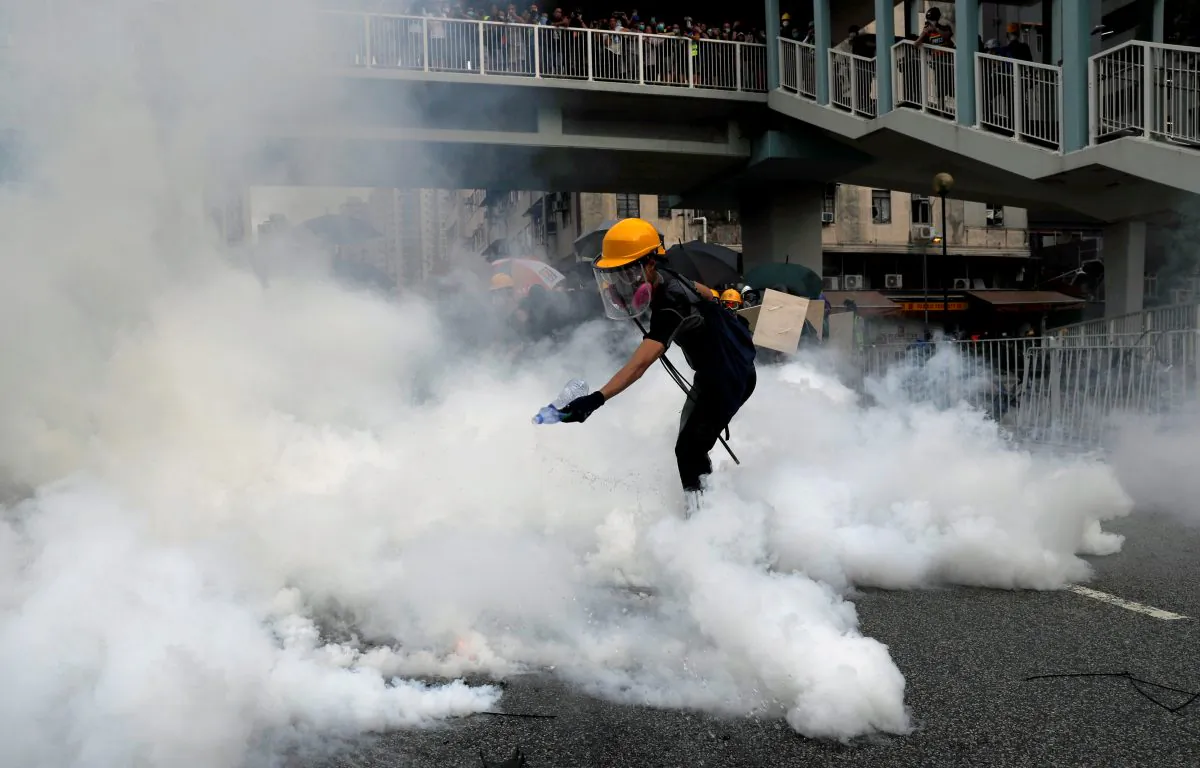 A demonstrator reacts to a tear gas during a protest against the Yuen Long attacks in Yuen Long, New Territories, Hong Kong, China on July 27, 2019. (Tyrone Siu/Reuters)