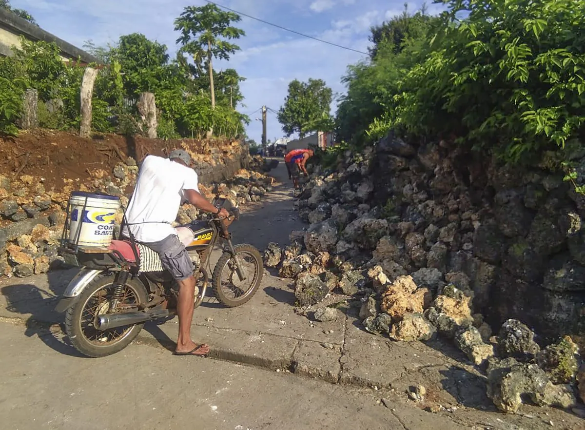 A resident looks at damages in Itbayat town, Batanes islands, northern Philippines on Saturday July 27, 2019. (AP Photo/Agnes Salengua Nico)