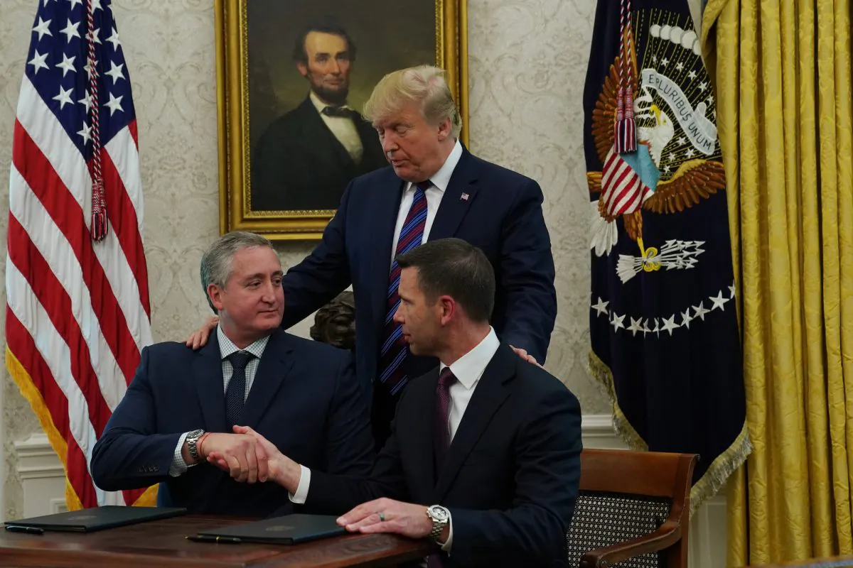 Acting U.S. Secretary of Homeland Security Kevin McAleenan shakes hands with Interior Minister of Guatemala Enrique Degenhart as U.S. President Donald Trump looks on after they signed a safe third country agreement in the Oval Office of the White House in Washington on July 26, 2019. (Alex Wong/Getty Images)