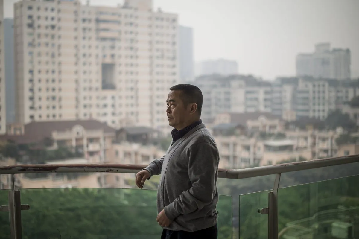 Chinese dissident Huang Qi poses in his apartment in Chengdu, Sichuan province on January 22, 2015. (FRED DUFOUR/AFP/Getty Images)