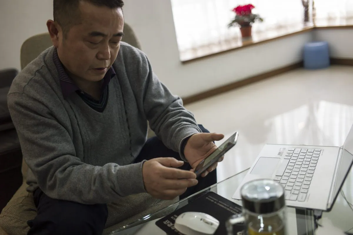 Chinese dissident Huang Qi poses in his apartment in Chengdu, Sichuan Province on Jan. 22, 2015. (Fred Dufour/AFP/Getty Images)