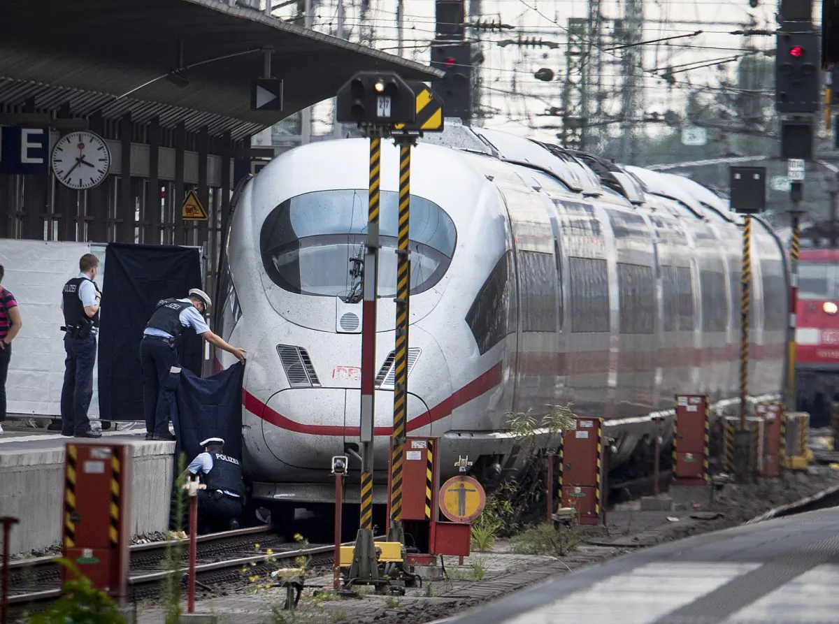 Police officers and rescue workers recover a body under an ICE highspeed train at the main station in Frankfurt, Germany on July 29, 2019. (AP Photo/Michael Probst)