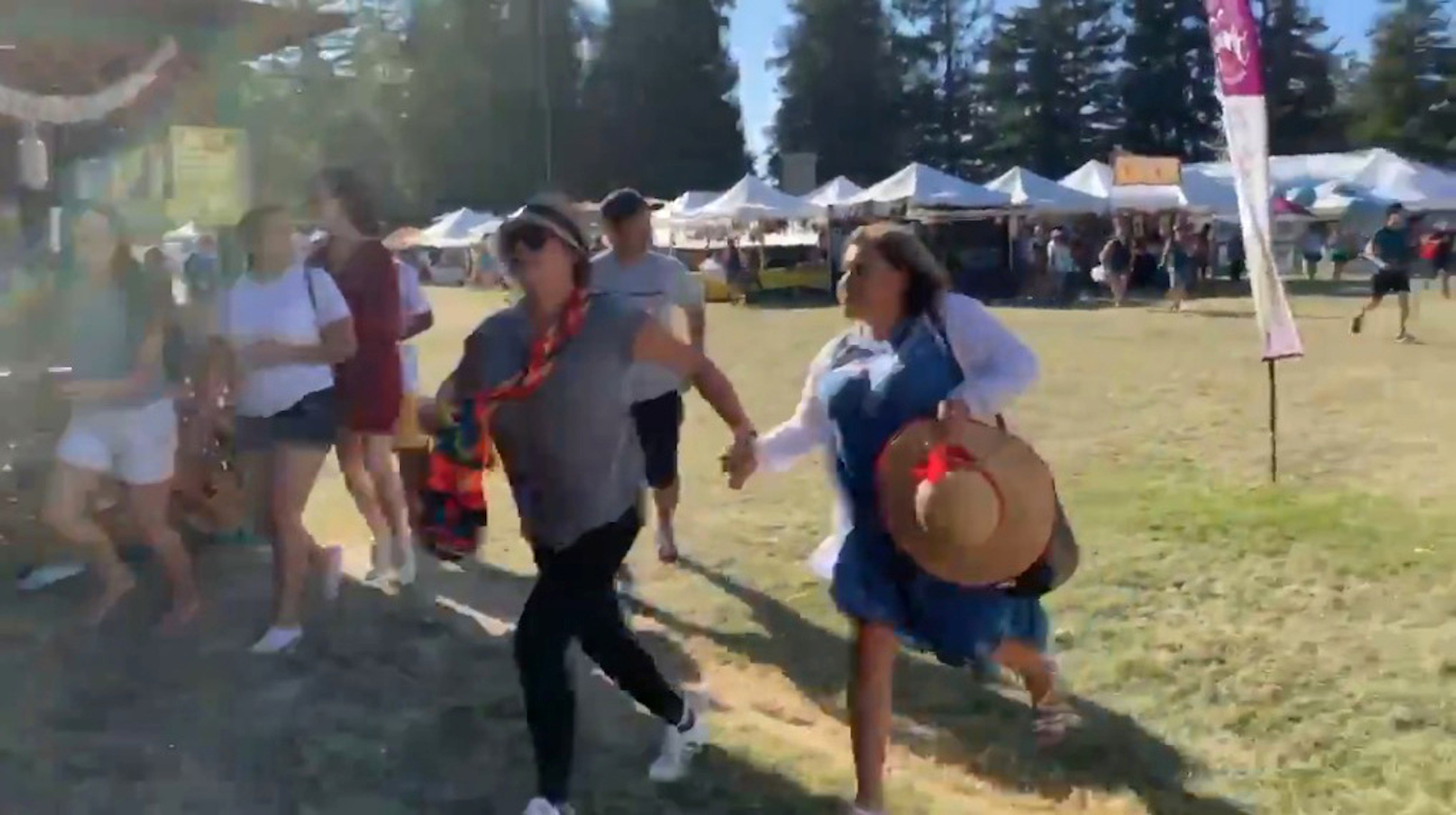 Social media video grab of people running away as an active shooter was reported at the Gilroy Garlic Festival, south of San Jose, California