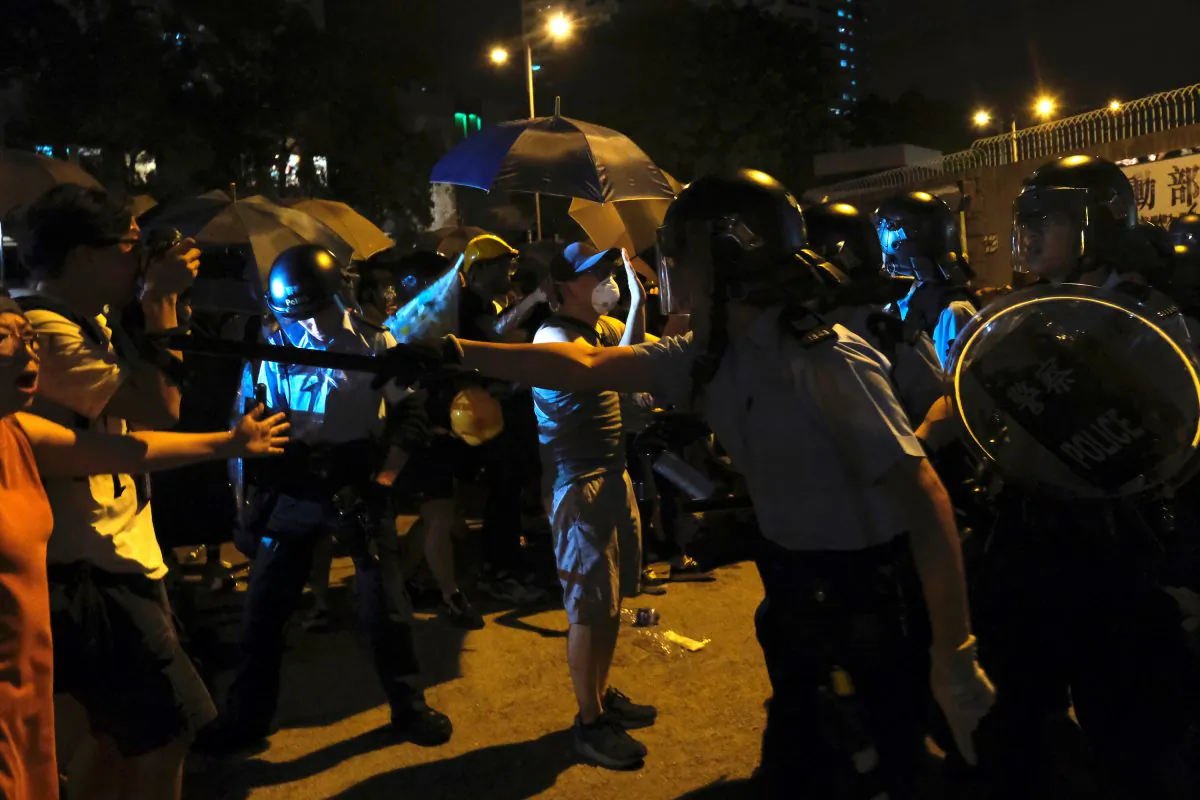 Police officers shout towards protesters who surrounded a police station where detained protesters are being held during clashes in Hong Kong, China on July 30, 2019. (Tyrone Siu/Reuters)