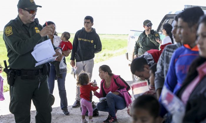 Border Patrol apprehends illegal aliens who have just crossed the Rio Grande from Mexico near McAllen, Texas, on April 18, 2019. (Charlotte Cuthbertson/The Epoch Times)