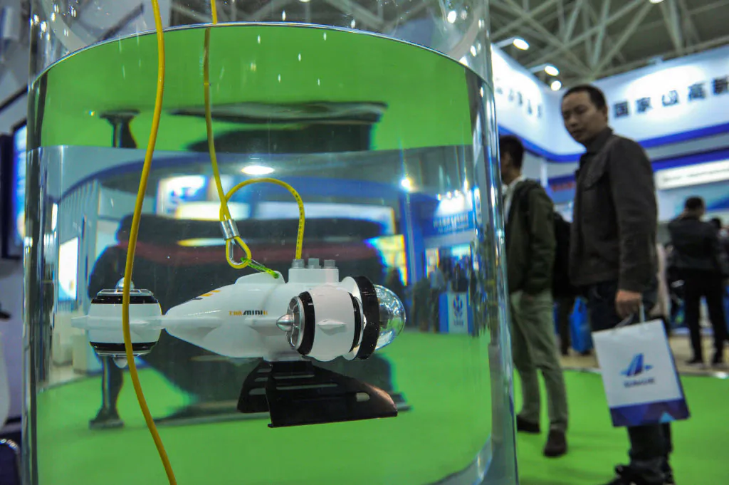 A visitor looks at an underwater robot during the Oceanology International China 2018 Expo in Qingdao, a city in eastern China's Shandong Province, on Oct. 23, 2019. (STR/AFP/Getty Images)