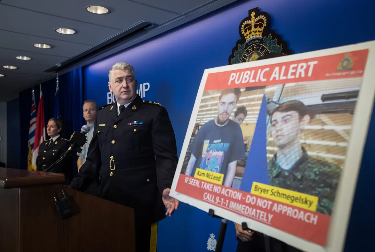 Security camera images of murder suspects Kam McLeod and Bryer Schmegelsky are displayed as RCMP Assistant Commissioner Kevin Hackett steps away from the podium after speaking during a news conference in Surrey, B.C., on July 23, 2019. (Darryl Dyck/The Canadian Press)