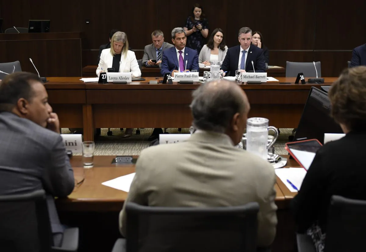 Conservative MPs Leona Alleslev, Pierre Paul-Hus and Michael Barrett sit across from Liberal MPs before an emergency meeting of the Standing Committee on Foreign Affairs and International Development to discuss a request to undertake a study of undue pressure on former career diplomats, in Ottawa on July 30, 2019. (Justin Tang/The Canadian Press)