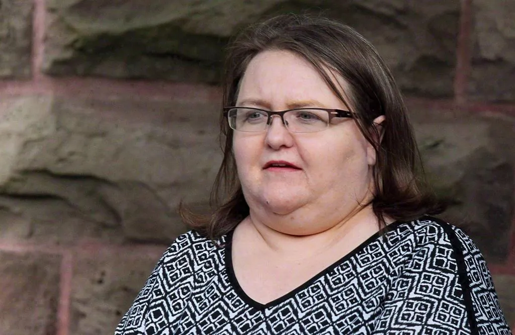 Elizabeth Wettlaufer is escorted by police from the courthouse in Woodstock, ON., on June 26, 2017. A public inquiry examining the case of a serial-killer nurse who preyed on elderly patients is set to deliver its report on July 31, 2019. (Dave Chidley/The Canadian Press)