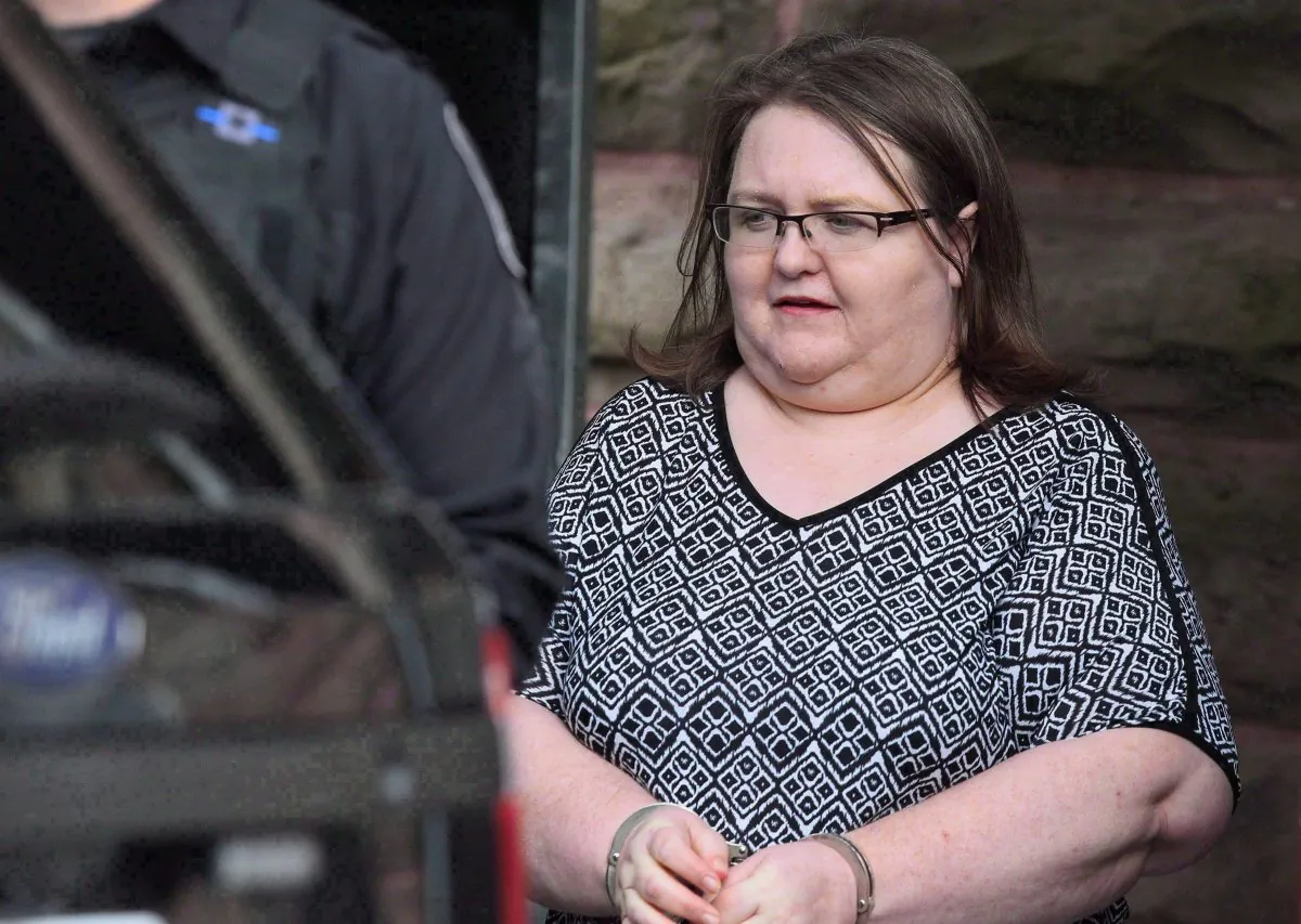 Elizabeth Wettlaufer is escorted by police from the courthouse in Woodstock, Ont, on June 26, 2017. The families of eight people killed by an Ontario nurse, as well as one of her surviving victims, lamented a fundamental lack of respect for human life in the province's long-term care system Monday as they addressed a public inquiry probing the circumstances around the woman's crimes. (Dave Chidley/The Canadian Press)