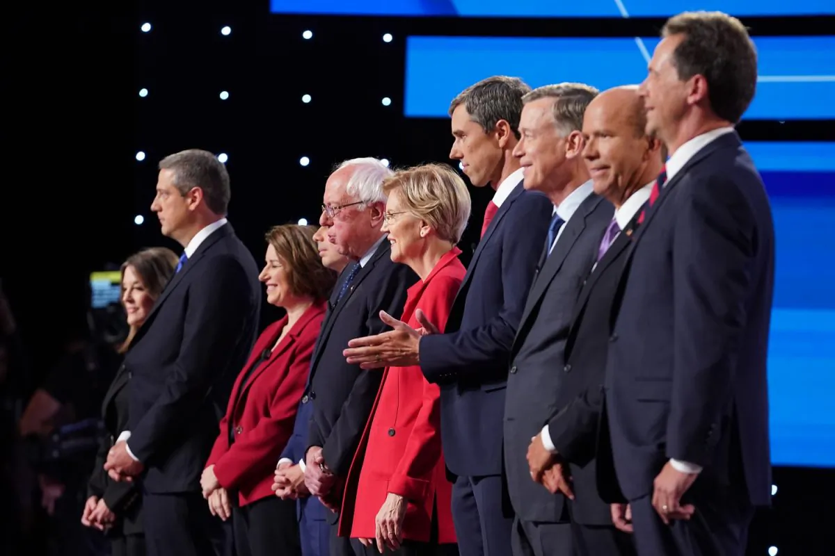 Democratic presidential candidates Marianne Williamson, (L-R), Rep. Tim Ryan (D-OH), Sen. Amy Klobuchar (D-MN), Indiana Mayor Pete Buttigieg, Sen. Bernie Sanders (I-VT), Sen. Elizabeth Warren (D-MA), former Texas congressman Beto O'Rourke, former Colorado governor John Hickenlooper, former Maryland congressman John Delaney, and Montana Gov. Steve Bullock take the stage at the beginning of the Democratic Presidential Debate at the Fox Theatre in Detroit, Michigan, on July 30, 2019. (Scott Olson/Getty Images)