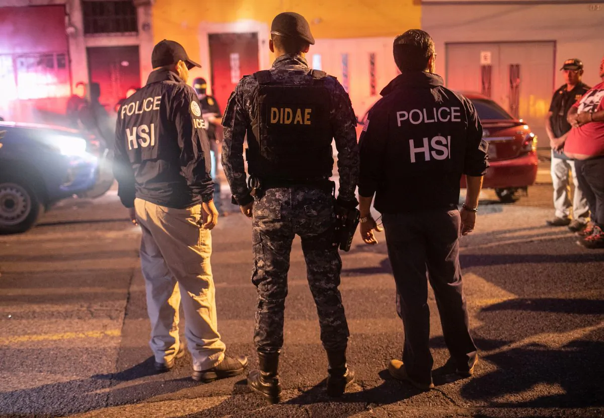 In this file image ICE agents with U.S. Homeland Security Investigations (HSI), and a Guatemalan policeman (C) stand at the scene of an early morning raid in Guatemala City on May 29, 2019. (John Moore/Getty Images)