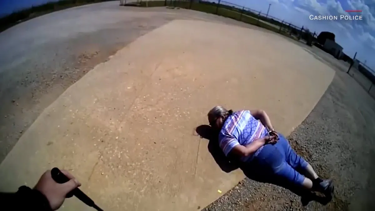 Debra Hamil, 65, on the ground after fighting Cashion Police Department officer. (Screenshot from video via Cashion Police Department/CNN)