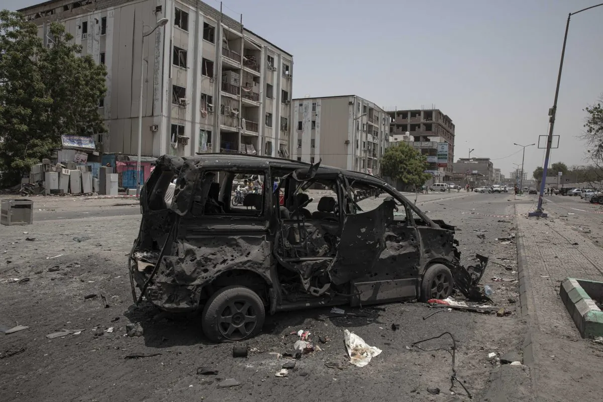 A destroyed vehicle remains at the site of a deadly attack on the Sheikh Othman police station in Aden, Yemen on Aug. 1, 2019. (AP Photo/Nariman El-Mofty)