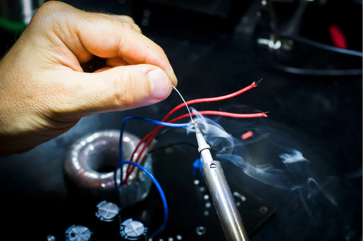 File photo of someone soldering electrical components. (Blaz Erzetic/Unsplash)