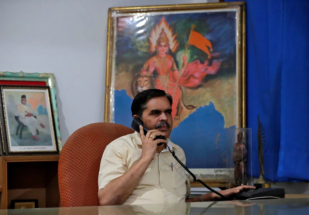 Ashwani Mahajan, chief of the Hindu nationalist Rashtriya Swayamsevak Sangh's (RSS) economic group Swadeshi Jagran Manch (SJM), poses for a photograph as he holds a phone inside his office in New Delhi, India on Oct. 31, 2018. (Altaf Hussain/Reuters)
