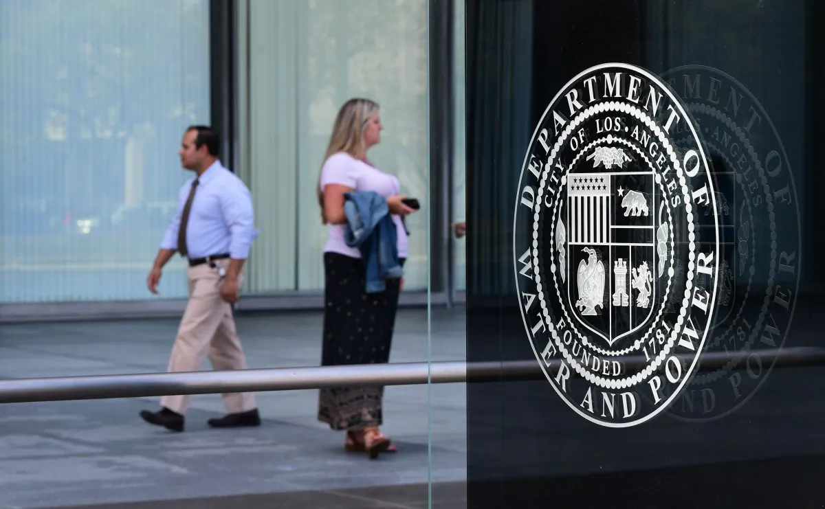Pedestrians walk past the Los Angeles Department of Water and Power headquarters in Los Angeles on July 22, 2019. (Frederic J. Brown/AFP/Getty Images)