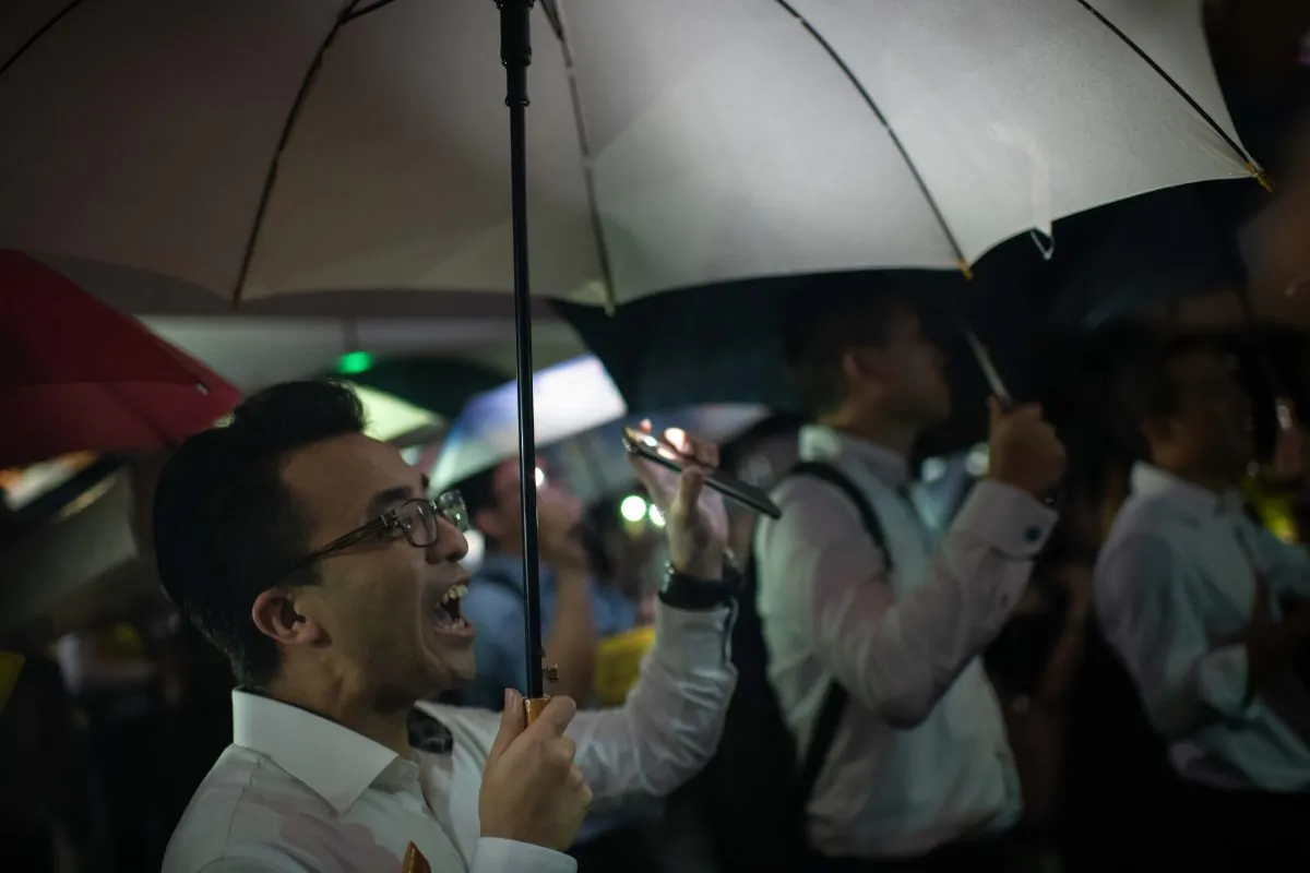 People from the finance community hold up umbrellas and shine lights during a rally against a controversial extradition bill in Hong Kong on Aug. 1, 2019. (Billy H.C. Kwok/Getty Images)