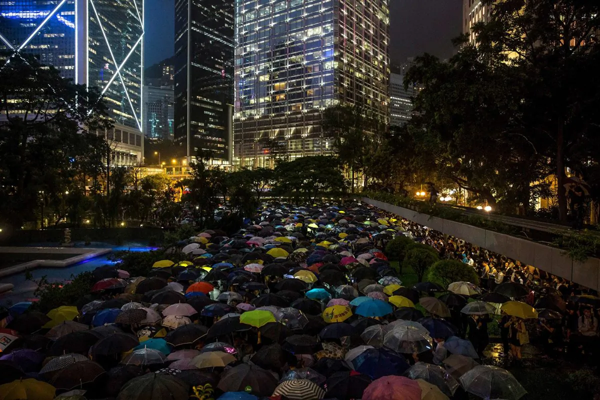 People from the finance community hold up umbrellas and shine lights during a protest against a controversial extradition bill in Hong Kong on August 1, 2019. (Isaac Lawrence/AFP/Getty Images)