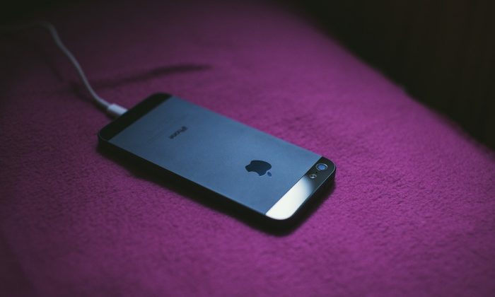 A stock photo shows an iPhone being charged in bed. (Pixabay)