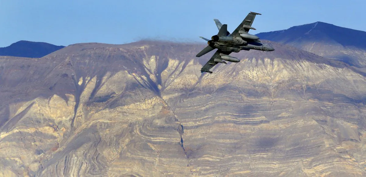 An F/A-18D Hornet from the VX-9 Vampire squadron at Naval Air Weapons Station China Lake, flies out of Star Wars Canyon toward the Panamint range in Death Valley National Park, Calif. on Feb. 27, 2017. (AP Photo/Ben Margot, File)
