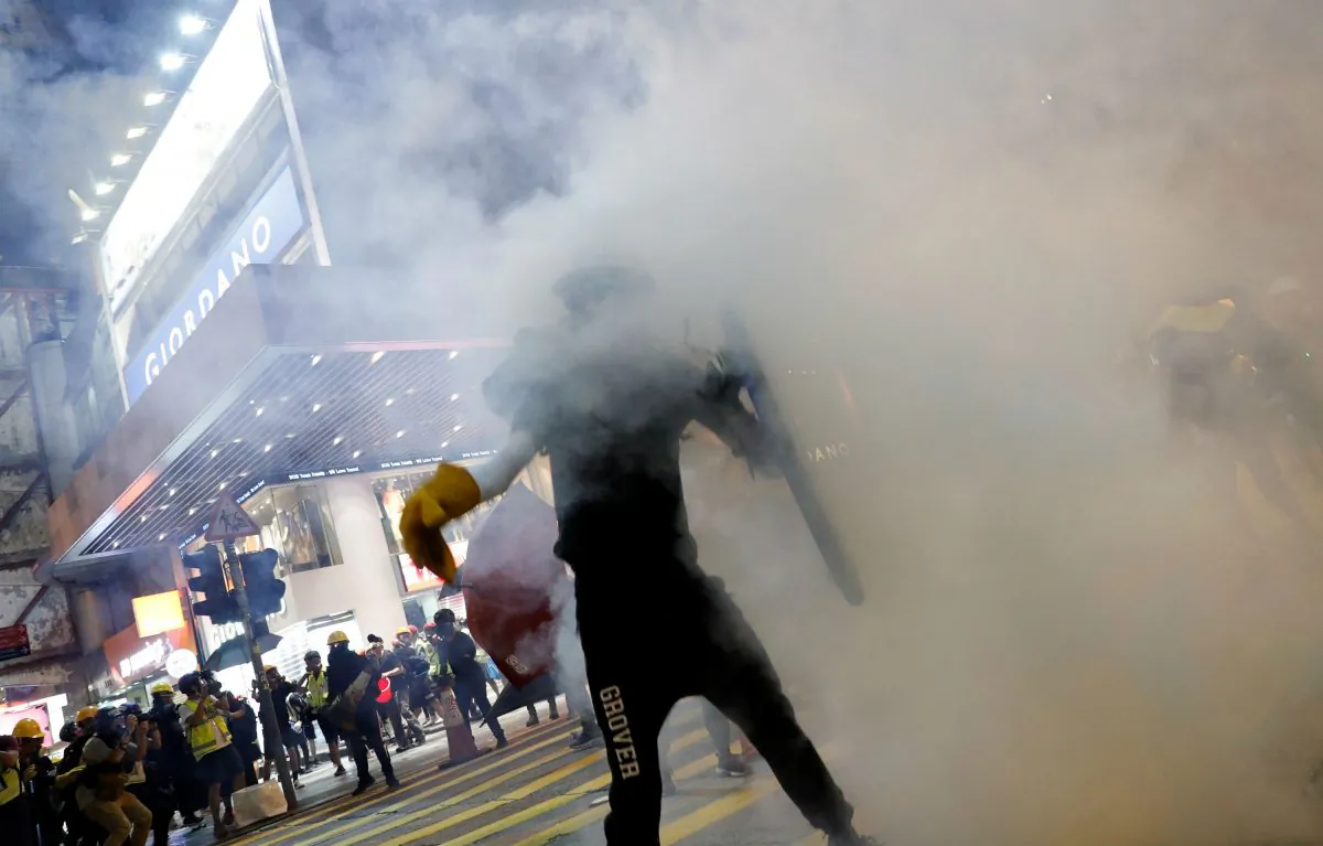 An anti-extradition bill protester is covered in tear gas during a march in Hong Kong, China, Aug. 3, 2019. (Reuters/Tyrone Siu)