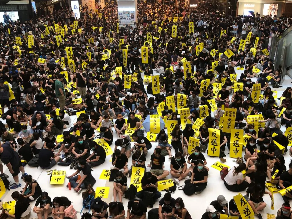 Protesters holding banners opposing the extradition bill in Hong Kong's New Town Plaza on Aug. 5, 2019. (Juliana Chu/The Epoch Times)