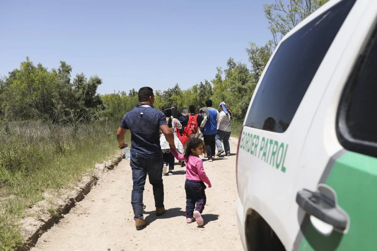 A group of illegal aliens walk up the road after crossing the Rio Grande from Mexico, near McAllen, Texas, on April 18, 2019. (Charlotte Cuthbertson/The Epoch Times)