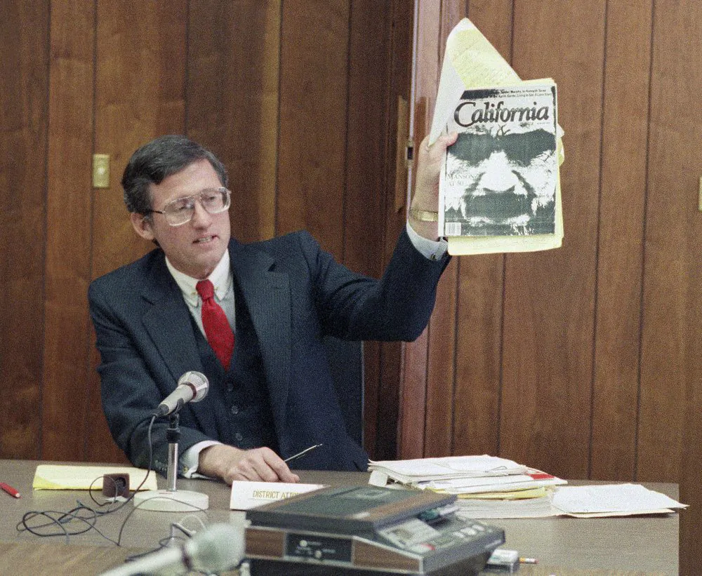 Los Angeles Deputy District Attorney Stephen Kay holds up a magazine profiling convicted murderer Charles Manson while delivering his closing statement at Manson's parole hearing at San Quentin Prison, Calif., on Feb. 9, 1989. (Eric Risberg/AP Photo)