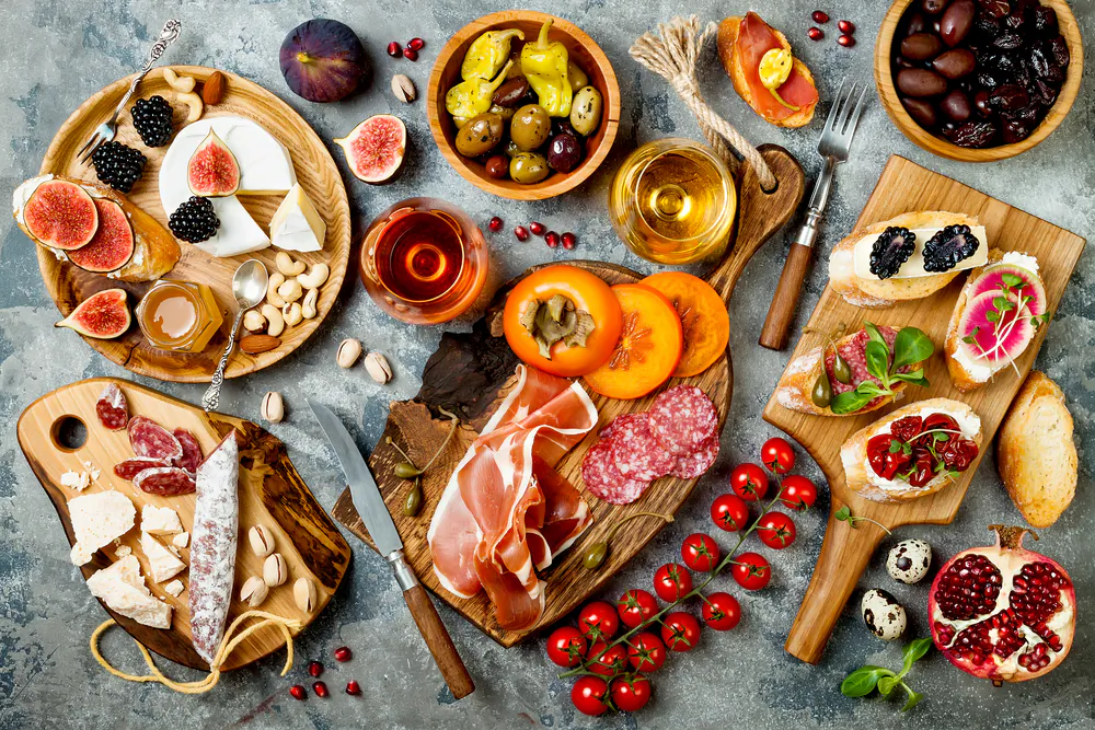 Prepare a couple kinds of bruschette and crostini, add a cheese and charcuterie board, and round it out with a good bottle of wine.(Shutterstock)