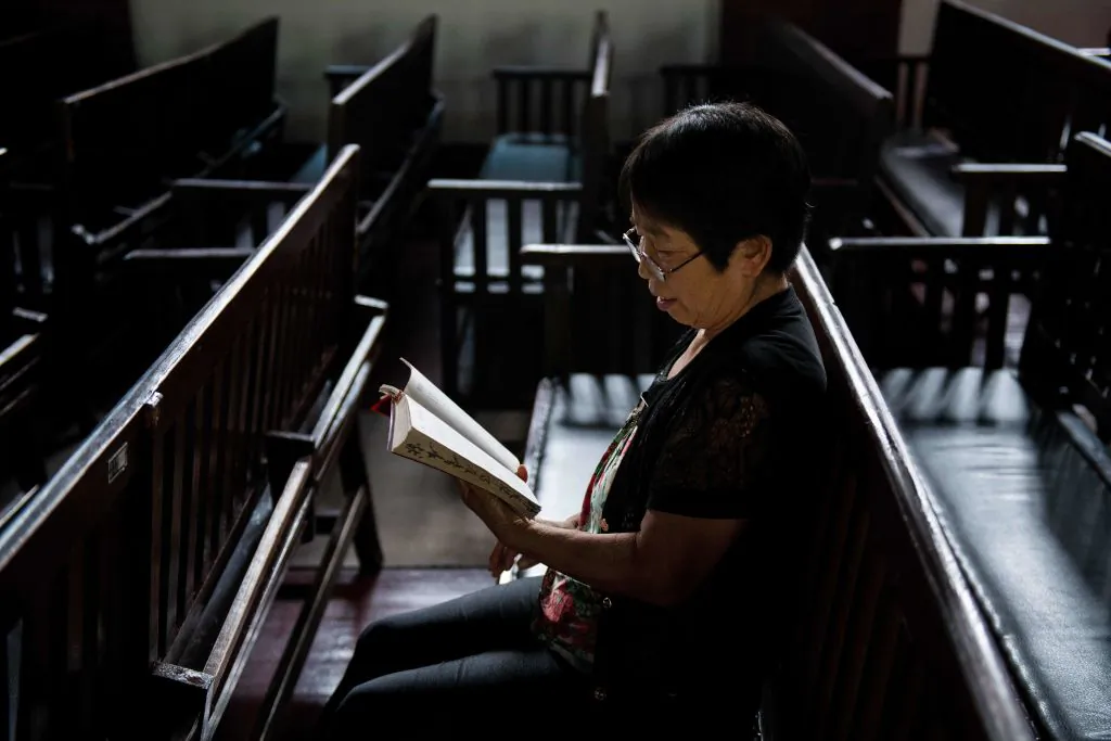 A woman reads the Bible at the Christian Glory church in Wuhan,a city in China's Hebei Province, on Sept. 23, 2018. (Nicolas Asfouri/AFP/Getty Images)