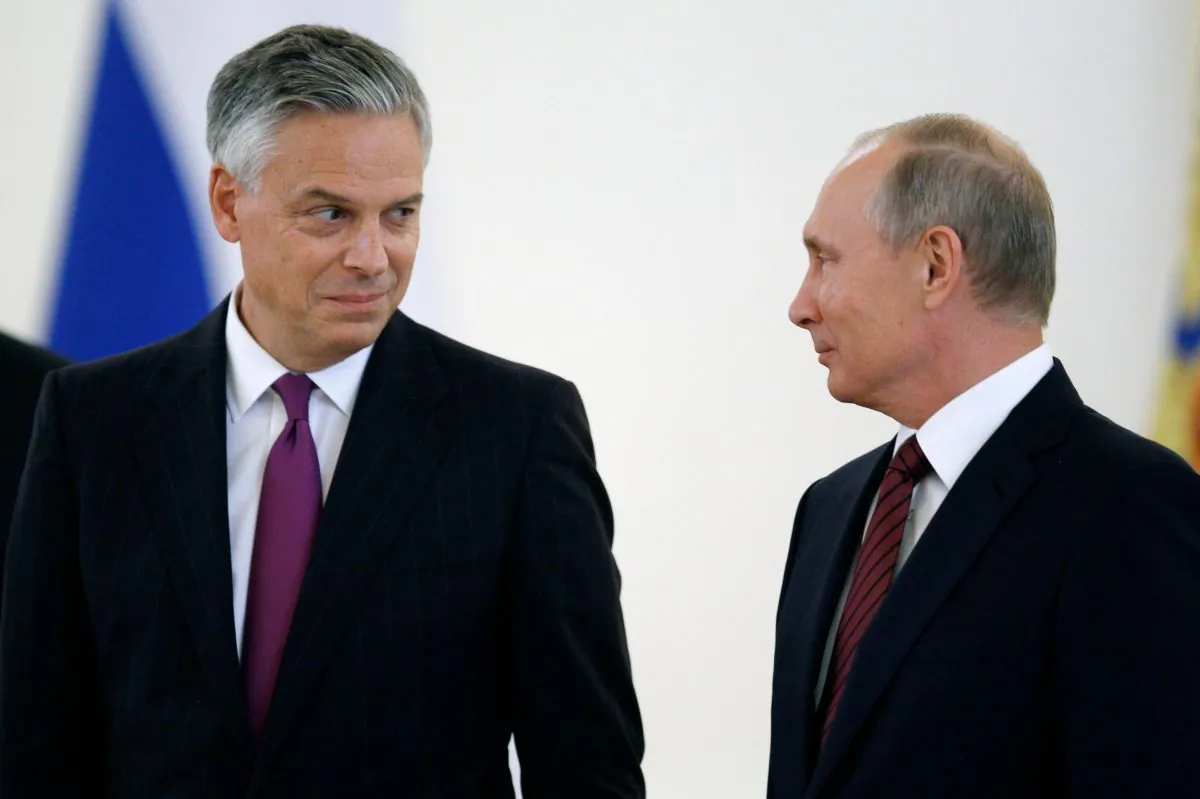 Russian President Vladimir Putin (R) looks at U.S. ambassador to Russia Jon Huntsman during a ceremony of receiving diplomatic credentials from foreign ambassadors at the Kremlin in Moscow on Oct. 3, 2017. (Pavel Golovkin/AFP/Getty Images)