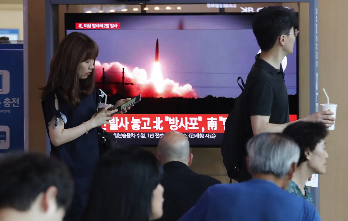 People watch a TV showing a file image of North Korea's missile launch during a news program at the Seoul Railway Station in Seoul, South Korea on Aug. 6, 2019. (Ahn Young-joon/AP)