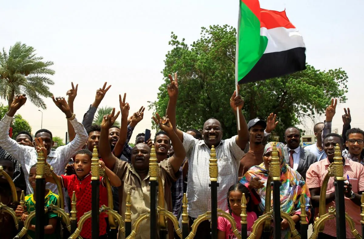 Sudanese people carry their national flag and chant slogans outside Friendship Hall, in Khartoum, Sudan, on Aug. 4, 2019. (Mohamed Nureldin Abdallah/Reuters)