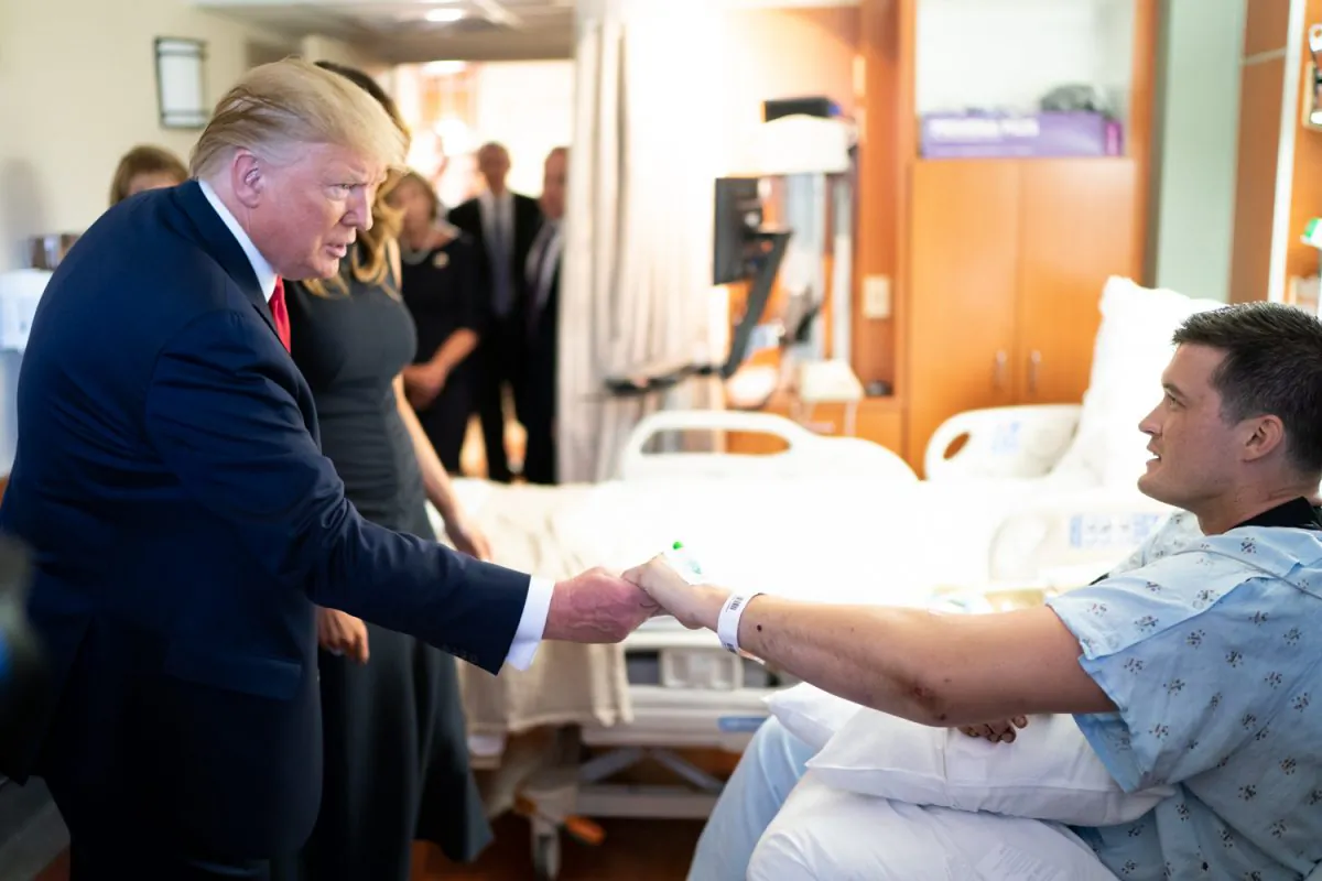 President Donald Trump and First Lady Melania Trump meet with a survivor of the Dayton shooting massacre at Miami Valley Hospital in Dayton, Ohio, on Aug. 7, 2019.  (Official White House Photo by Andrea Hanks)