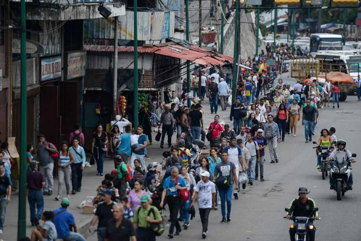 People walk back home in the Petare neighborhood after Caracas and other parts of Venezuela were hit by a massive power cut on July 22, 2019. (Matias Delacroix/AFP/Getty Images)