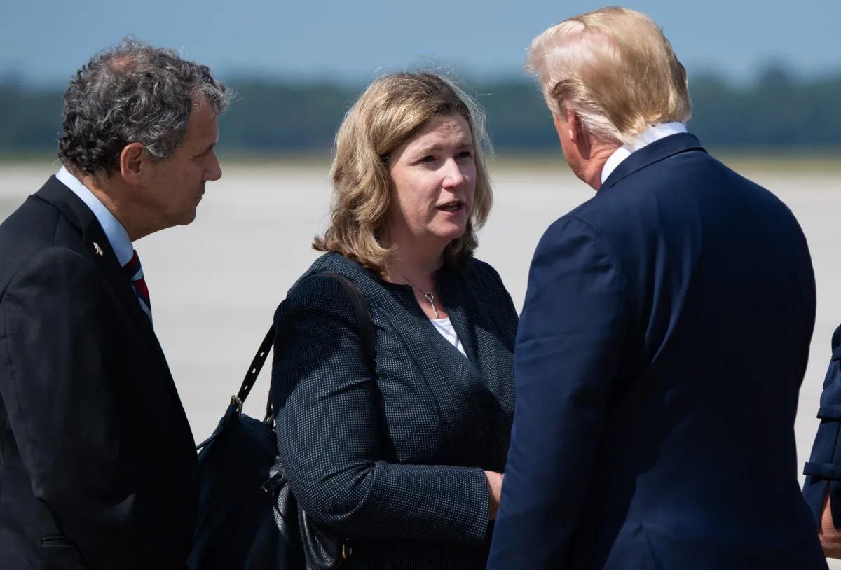 President Donald Trump greets Dayton Mayor Nan Whaley (C) as he arrives at Wright-Patterson Air Force Base in Ohio on Aug. 7, 2019. (Saul Loeb/AFP/Getty Images)