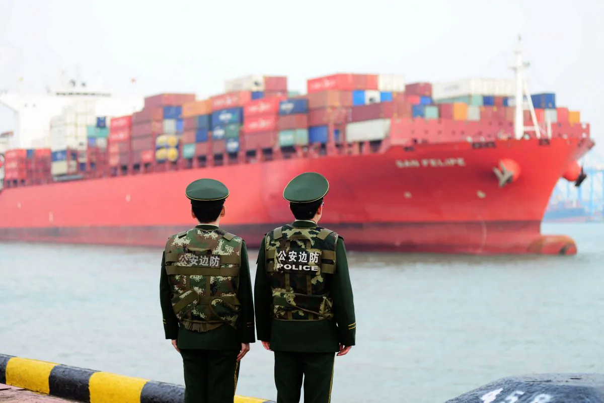 Chinese police officers watch a cargo ship at a port in Qingdao in China's eastern Shandong Province on March 8, 2018.
(AFP/Getty Images)