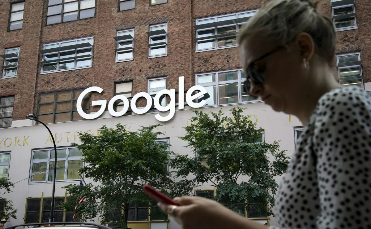 A woman looks at her smartphone as she walks past Google Building 8510 at 85 10th Ave., New York City, N.Y., on June 3, 2019. (Drew Angerer/Getty Images)