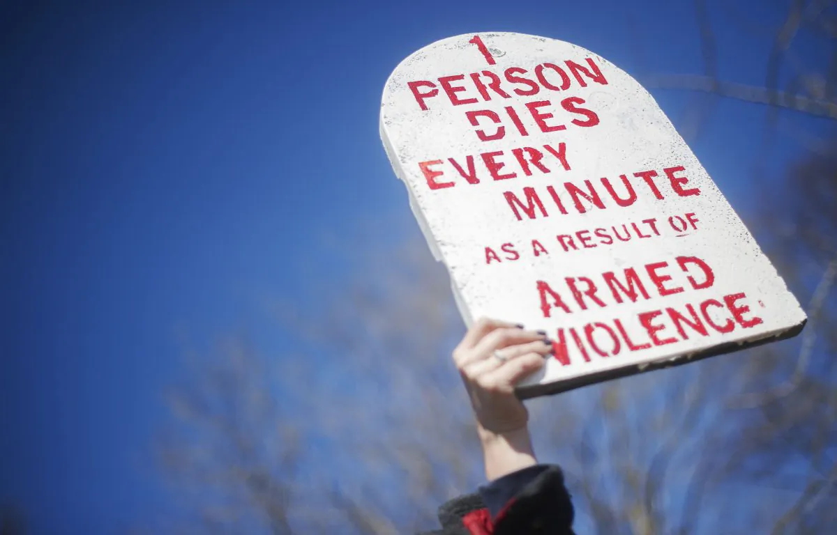 A demonstrator from Amnesty International holds up a placard outside the White House on March 22, 2013 in in Washington., (JIM WATSON/AFP/Getty Images)