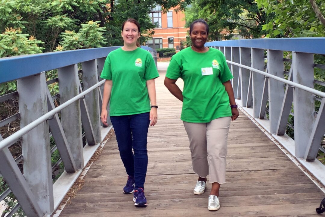 Sonia Anderson and Landy Sorensen often walk together on Friday mornings while volunteering at a local food bank. The friends track each other’s progress on their cellphone apps and compete to see who logs the most steps. (Bruce Horovitz/KHN)